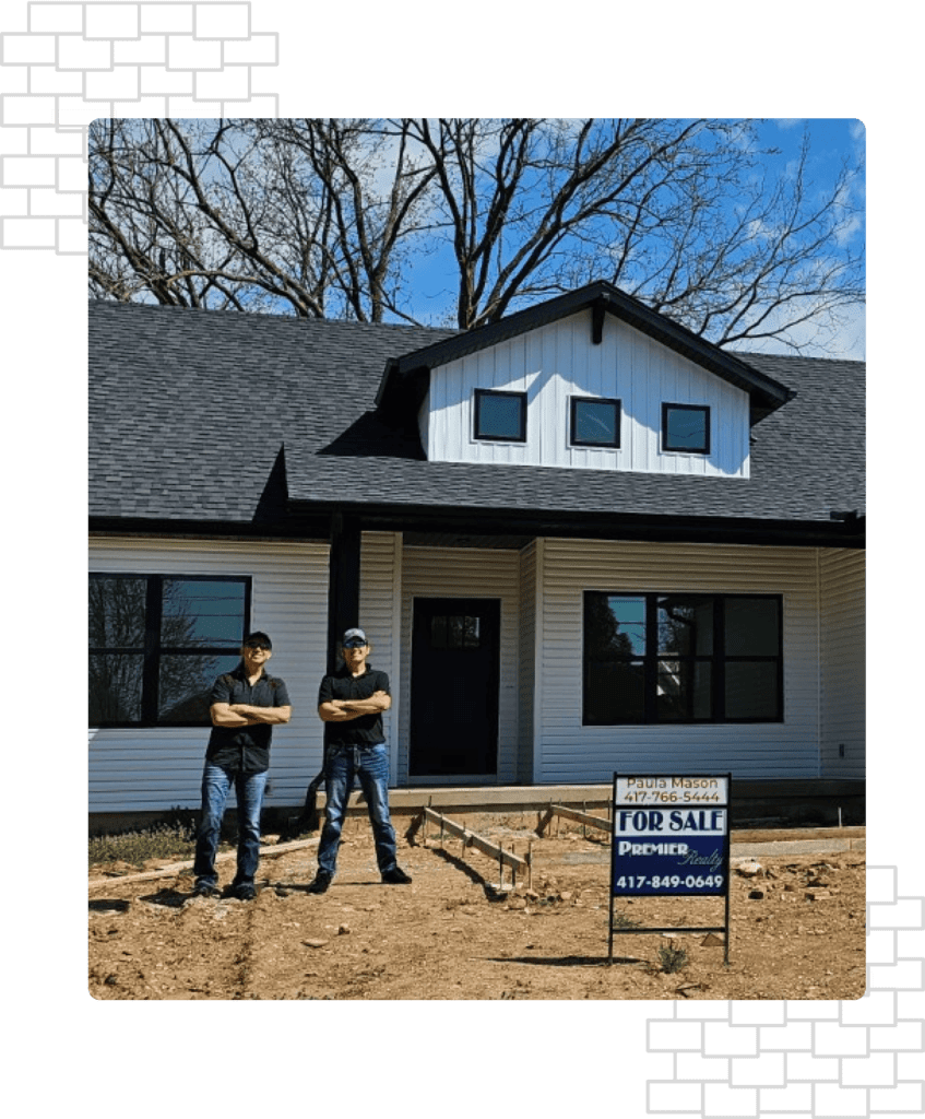 Two men from BG Roofing standing in front of the house after roofing installation